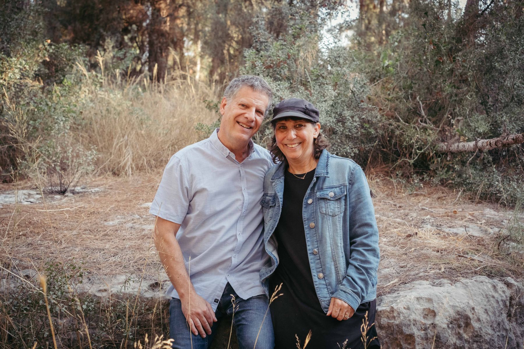 Couple laughing in a pine forest